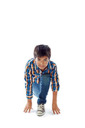 Photo for Ready, set, grow. Studio portrait of a young boy in a starting position against a white background - Royalty Free Image