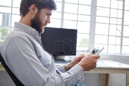 Photo for Technology has all the answers. a young designer using his digital tablet - Royalty Free Image