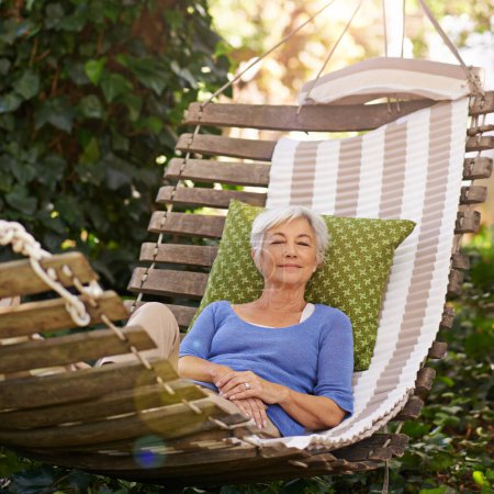 Photo for Elderly, woman and sleep on hammock during retirement and relax on summer vacation with happiness. Garden, senior person nap and rest with smile during spring while happy and at peace in nature. - Royalty Free Image