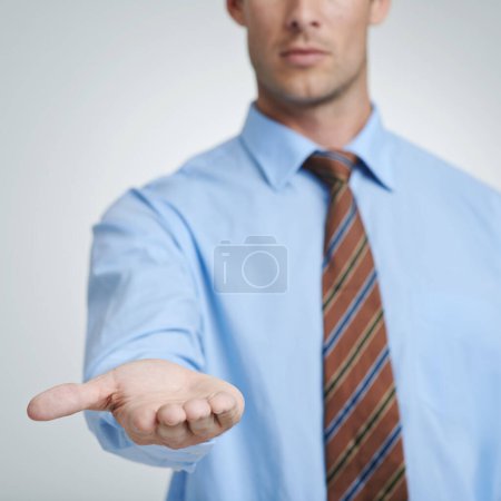 Photo for Looking for a corporate bailout. Studio shot of a businessman with his open palm raised to the camera - Royalty Free Image