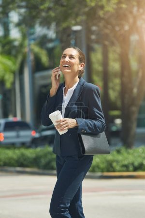 Photo for The joys of having a successful career. a young businesswoman talking on her phone while out in the city - Royalty Free Image
