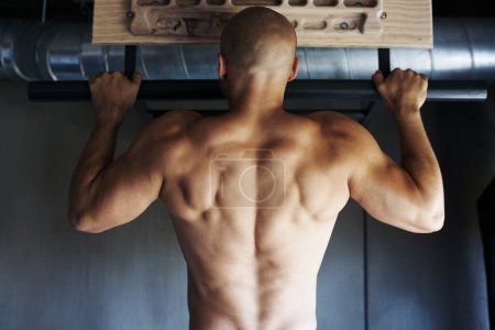 Photo for Turn up the intensity. a man doing pull-ups at the gym - Royalty Free Image