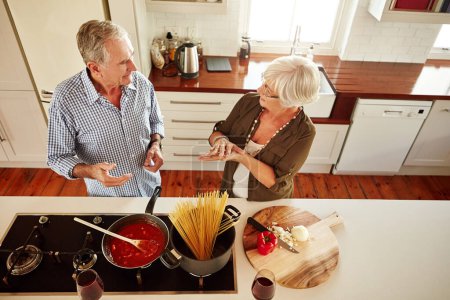 Photo for Bonding over the stove. a couple cooking a meal together at home - Royalty Free Image