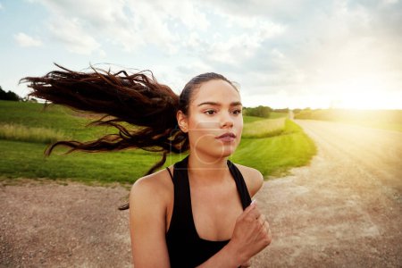 Photo for If it burns, youre doing it right. a fit young woman out for a run on a beautiful day - Royalty Free Image