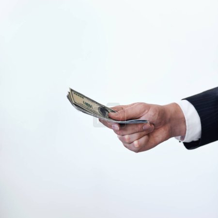 Photo for This is a once-off deal. Conceptual shot of a businessman stretching out his hand holding money - Royalty Free Image
