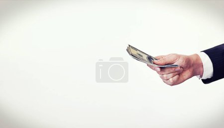 Photo for This is a once-off deal. Conceptual shot of a businessman stretching out his hand holding money - Royalty Free Image