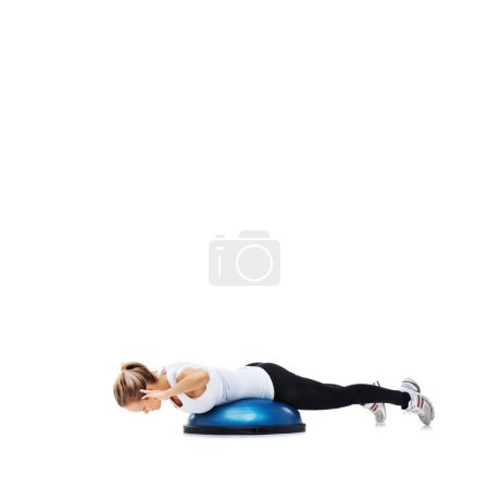 Photo for Shes working on her abs. A young woman working her core on a bosu-ball - Royalty Free Image