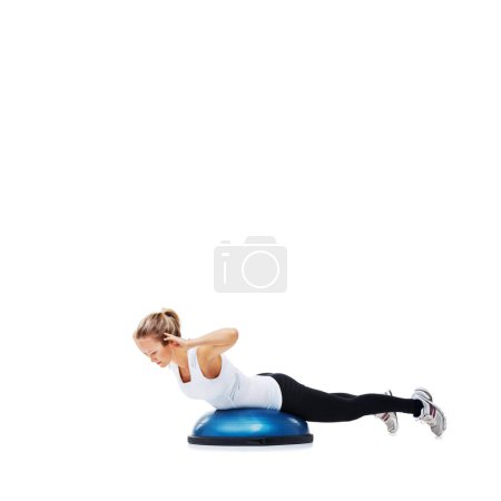 Photo for Shes working up a proper workout sweat. A young woman working her core on a bosu-ball - Royalty Free Image