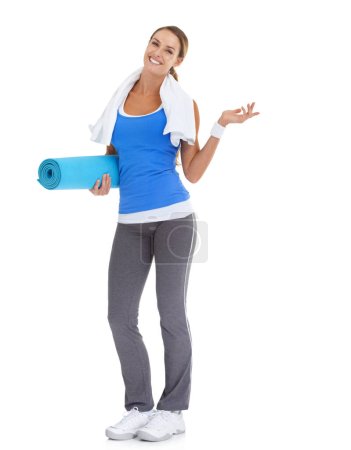 Photo for Suggesting a great fitness alternative...Fit young woman holding a pilates mat with a smile - isolated on white - Royalty Free Image