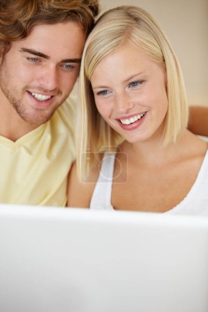 Foto de Video chat con seres queridos. Una feliz pareja joven video chat en línea con amigos y familiares - Imagen libre de derechos