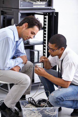 Photo for He knows what your network needs. A young IT specialist ready to fix a server - Royalty Free Image