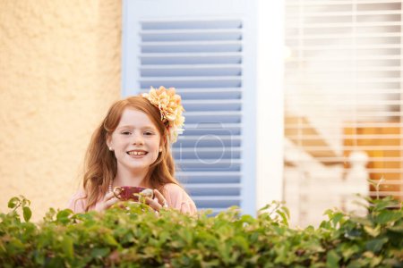 Photo for Joys of childhood...A little redheaded girl standing outside smiling at the camera - Royalty Free Image