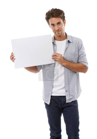 Photo for Ive got your copyspace right here. Portrait of a handsome young man holding a sign for your copyspace - Royalty Free Image