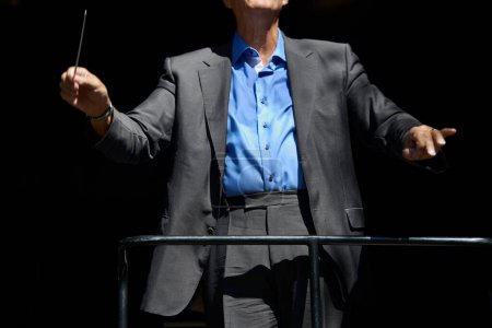Photo for Letting the music flow. Cropped view of an orchestra conductor holding his baton - Royalty Free Image