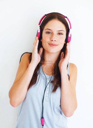 Photo for Music headphones, portrait and happy woman listen to fun girl song, wellness audio podcast or radio sound. Studio smile, freedom and gen z model streaming edm playlist isolated on white background. - Royalty Free Image