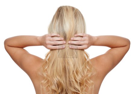 Foto de Su cabello es su gloria suprema. Vista trasera de una mujer joven con el pelo largo y rubio aislado en blanco - Imagen libre de derechos