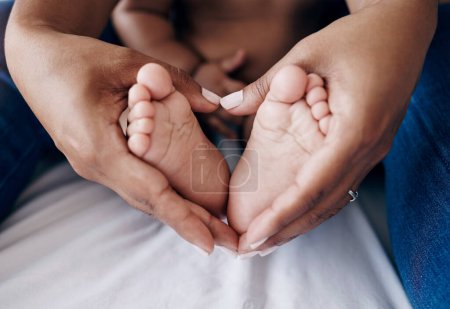 Photo for These little feet will always have my heart. an unrecognisable woman sitting on the bed at home and holding her babys feet - Royalty Free Image