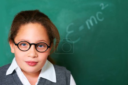 Photo for Shes a young science wizz. Portrait of a cute brunette girl in class - Royalty Free Image