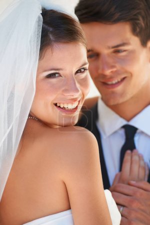 Téléchargez les photos : C'est le plus beau jour de ma vie. Une belle mariée regardant par-dessus son épaule et souriant - en image libre de droit