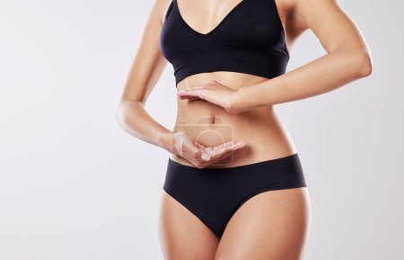 Photo for Discover just how wonderful your body is. a woman forming a frame over her stomach - Royalty Free Image