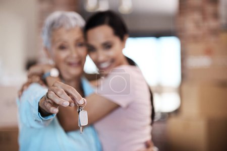 Photo for What makes a home are the memories made in it. a senior woman standing next to her daughter and holding up the keys to her new home - Royalty Free Image
