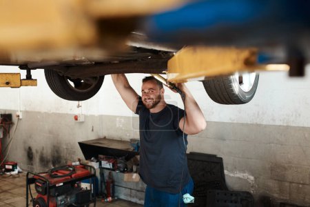 Photo for I make sure everything is good to ensure your adventure is a safe one. a mechanic working under a lifted car - Royalty Free Image