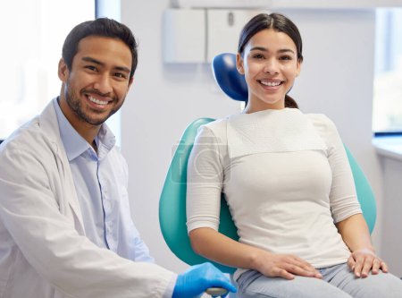 Photo for Healthy teeth, happy patient. Portrait of a young woman having a consultation with her patient in a dentists office - Royalty Free Image