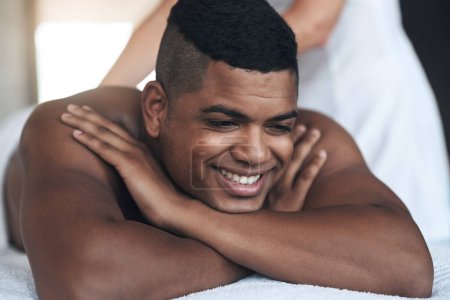 Photo for This sure feels good. a young man getting a back massage at a spa - Royalty Free Image