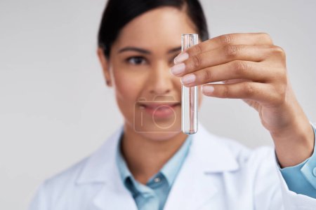 Photo for Lets see whats gonna happen. an attractive young female scientist examining a vial filled with liquid in studio against a grey background - Royalty Free Image