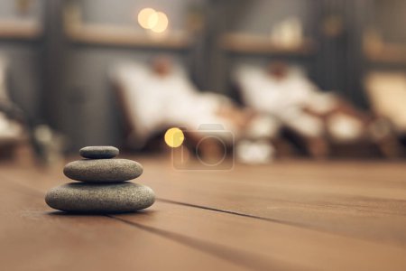 Photo for Well introduce you to a whole new world of tranquility. three stones balanced on top of each other in a spa - Royalty Free Image