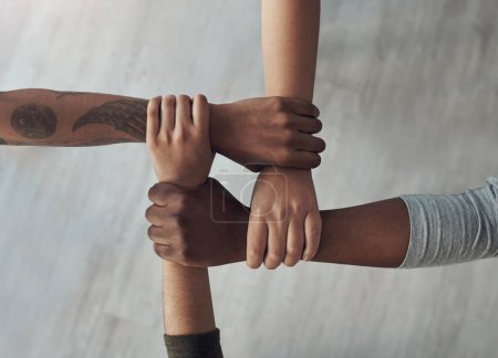 Photo for We hold one another accountable. a group of unrecognizable people holding each others wrists - Royalty Free Image