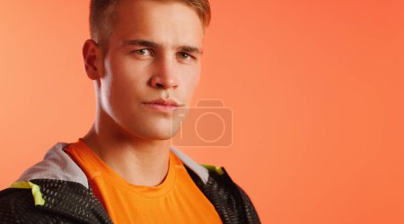 Photo for Face each challenge with renewed vigour. Studio portrait of a handsome young man posing against a peach background - Royalty Free Image