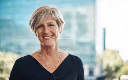 Photo for Confidence came with experience. Portrait of a confident mature businesswoman against a city background - Royalty Free Image