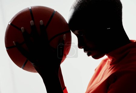 Photo for More than sport,its a spiritual experience. Studio shot of an attractive young woman playing basketball against a grey background - Royalty Free Image