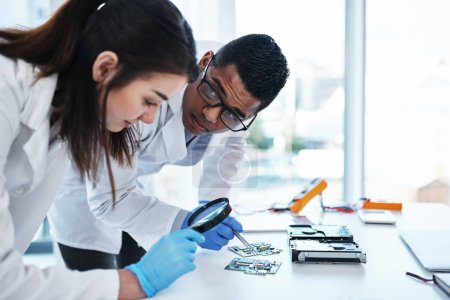 Photo for A tech savvy team to support any IT system. a young man and woman repairing computer hardware in a laboratory - Royalty Free Image