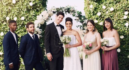 Photo for Its simply a beautiful day. Cropped portrait of an affectionate young newlywed couple standing with their groomsmen and bridesmaids on their wedding day - Royalty Free Image