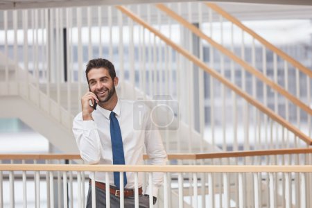 Photo for Dont hangup when youre on the line with opportunity. a young businessman talking on a cellphone in an office - Royalty Free Image