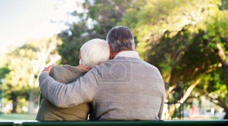 Photo for This is what forever means. Rearview shot of an affectionate senior man embracing his wife while relaxing at the park - Royalty Free Image