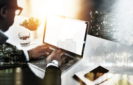 Photo for Focused on beating the deadline. High angle shot of an unrecognizable young businessman working on his laptop in a modern office - Royalty Free Image