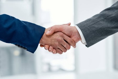 Photo for Working with each other to get the best results. Closeup shot of two unrecognisable businesspeople shaking hands in an office - Royalty Free Image