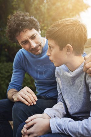 Photo for Family, father and son have conversation in backyard, bonding with love and care, communication and relationship. Man help by giving teen boy advice at home, outdoor together with trust and support. - Royalty Free Image
