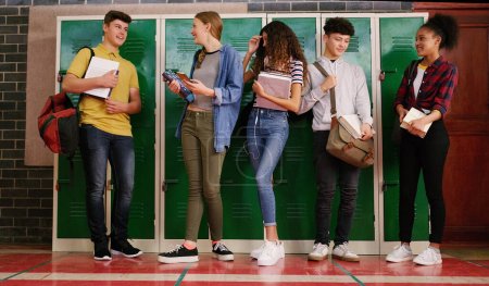 Photo for Some banter before class. a group of cheerful young school kids talking to each other before class inside of a school during the day - Royalty Free Image