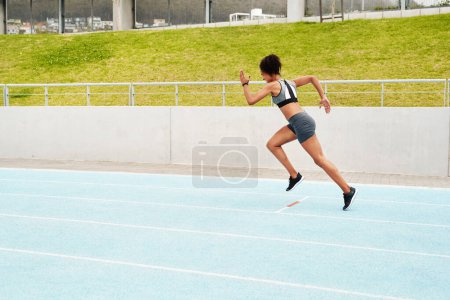 Photo for The finish line is my only limit. Full length shot of an attractive young athlete running a track field alone during a workout session outdoors - Royalty Free Image