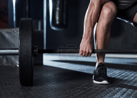 Photo for To get stronger, get lifting. an unrecognisable man lifting a barbell during his workout at a gym - Royalty Free Image