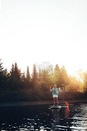 Photo for This is my kinda activity. a young woman paddle boarding on a lake - Royalty Free Image