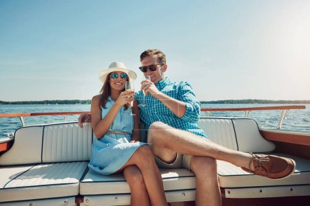Photo for Bubbly on board. a young couple having champagne on a boat ride - Royalty Free Image