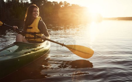 Photo for The best way to start the day. a beautiful young woman kayaking on a lake outdoors - Royalty Free Image