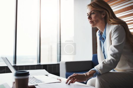 Photo for When it comes to success, shes fully focused. an attractive businesswoman working in her corporate office - Royalty Free Image