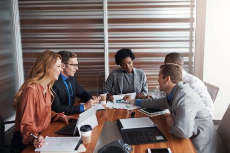 Photo for Highlighting a point based off their stats. a group of businesspeople having a meeting in an office - Royalty Free Image