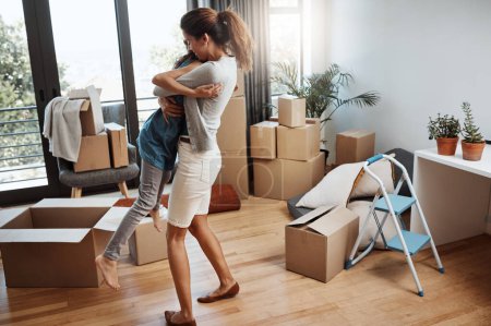 Photo for New beginnings bring about new hope. Full length shot of an attractive young woman and her daughter dancing while moving into their new home - Royalty Free Image